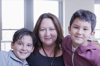 Hispanic mother posing with sons
