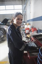 Portrait of smiling Hispanic mechanic