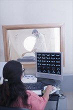 Hispanic nurse examining scanner results