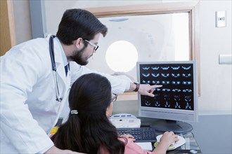 Hispanic doctor and nurse examining scanner results
