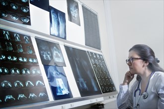 Hispanic doctor examining x-rays