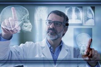 Hispanic doctor examining x-rays on virtual screen