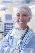 Portrait of smiling Hispanic surgeon