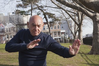 Hispanic man performing exercise in park