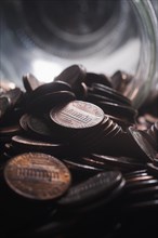 Pile of pennies near jar