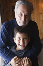 Portrait of smiling Hispanic grandfather and grandson