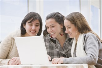 Hispanic women looking at laptop