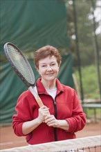 Senior Hispanic woman playing tennis