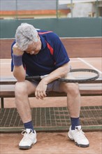 Senior Hispanic man unhappy after tennis game