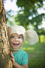 Caucasian girl in mouse costume standing near tree