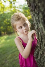Caucasian girl looking at tree
