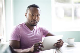 Black man using digital tablet