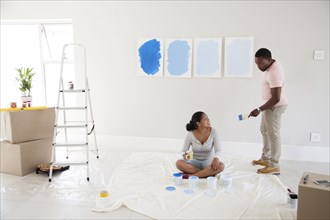 Couple examining paint samples in new home