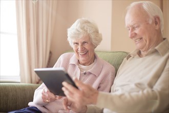 Older Caucasian couple using digital tablet