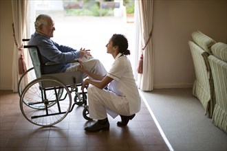 Nurse talking to patient in wheelchair