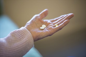 Older Caucasian woman holding medication