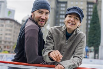 Portrait of smiling Caucasian couple at ice skating rink