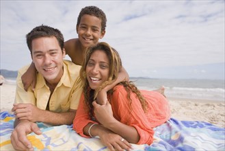 Family lying on the beach