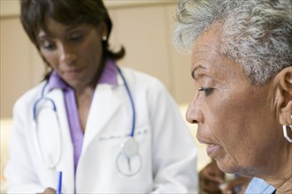 African female doctor with senior patient