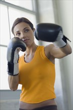 Mixed race woman boxing