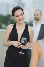Cuban woman holding wine glass