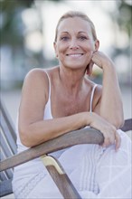 Brazilian woman sitting in lounge chair