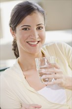 Close up of Cuban woman holding water glass