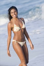 Hispanic woman in bikini at beach