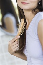 Hispanic woman brushing her hair