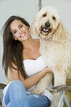 Hispanic woman sitting with dog