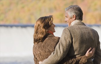 Caucasian couple hugging outdoors