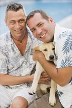 Caucasian couple holding dog
