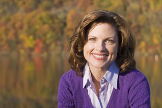 Smiling Caucasian woman outdoors in autumn