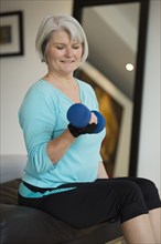 Caucasian woman exercising with hand weights