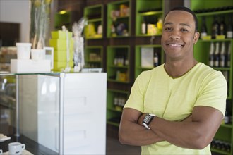 Mixed race business owner standing in shop