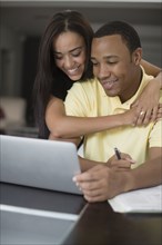 Mixed race couple using laptop