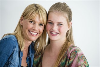Smiling Caucasian mother and daughter