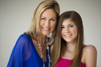 Caucasian mother and daughter smiling