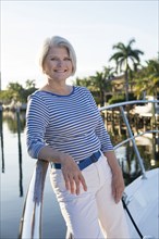 Older Caucasian woman smiling on boat deck