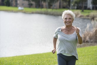 Senior Caucasian woman jogging in park
