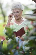 Senior Caucasian woman using digital tablet outdoors