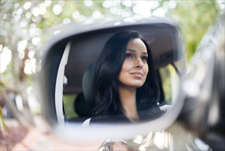 Hispanic woman driving car