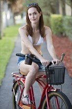 Caucasian woman on bicycle on suburban street