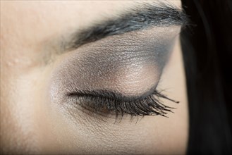Close up of makeup on eyelid of Hispanic woman