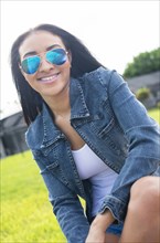 Close up of Black woman in sunglasses smiling