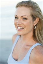 Caucasian woman smiling on beach