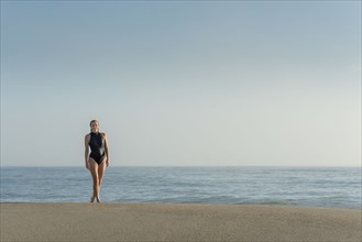 Caucasian woman wearing swimsuit on beach