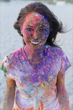 Caucasian woman splattered with paint powder
