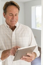 Caucasian man using digital tablet