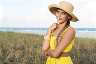 Caucasian woman wearing sun hat near beach